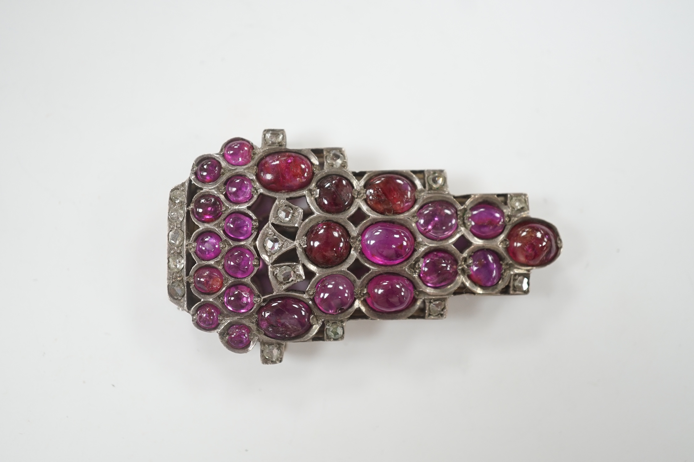 A 1920's? continental white metal cabochon ruby and rose cut diamond set clip brooch, 49mm.